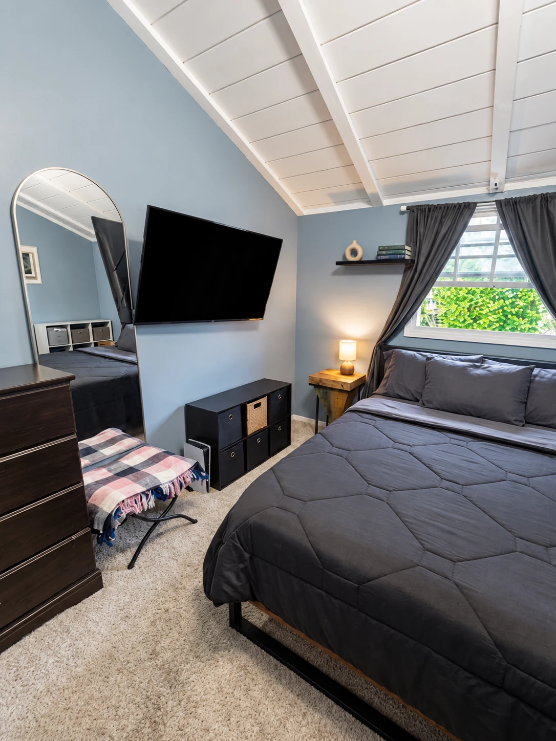 Another angle of the Citronia Recovery bedroom with the bed, television, dresser, and window
