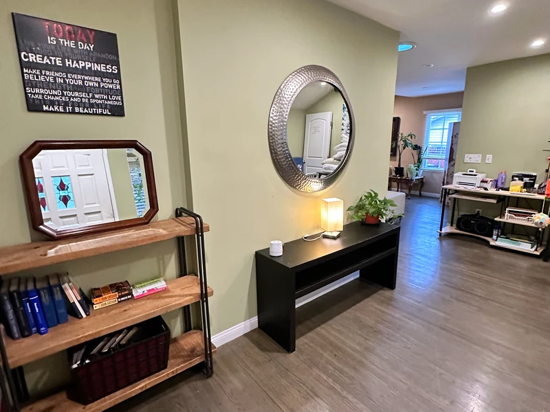 Entry and hallway at Citronia Recovery, with mirrors, books, a lamp and plants