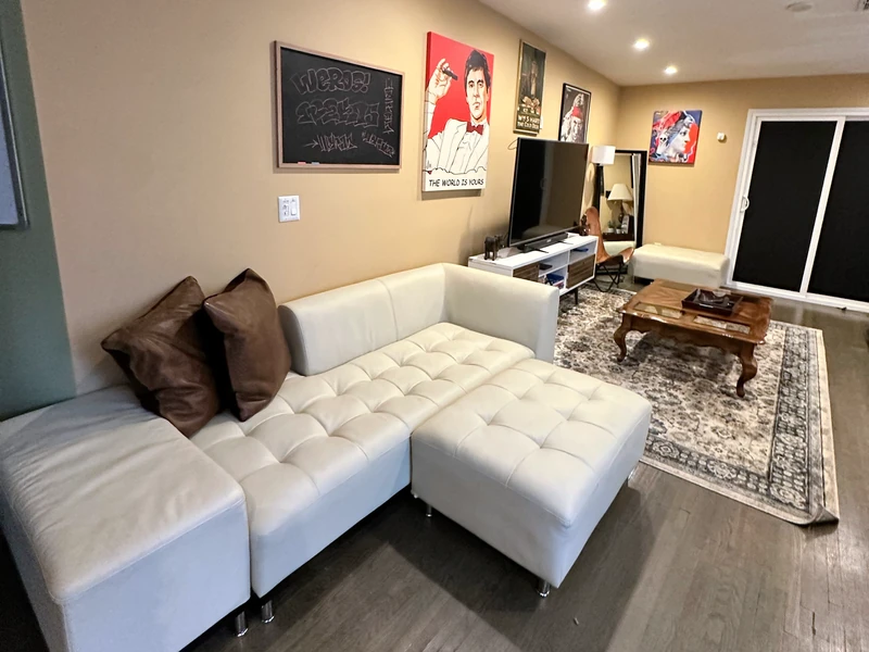 White sofa and ottoman in the same shared living room at Citronia Recovery