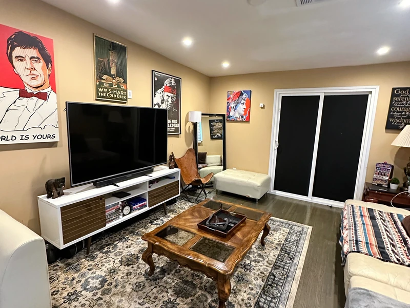 Another view of the same Citronia living room, showing the television, coffee table and seating